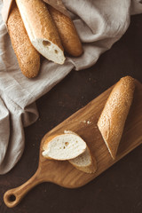 Fototapeta na wymiar French baked baguettes. Slices of sliced bread.