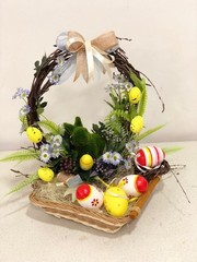 basket with easter eggs and flowers