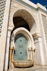 Traditional Tap Wall Fountain decorated with colorful shapes of mosaic, Hassan II Mosque in...