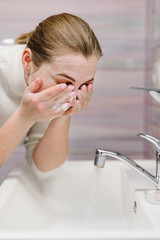 Coronavirus prevention. Wash face with antibacterial soap and running water in sink. Washing face. Epidemic Covid-19. Coronavirus prevention body hygiene. Flu disease.