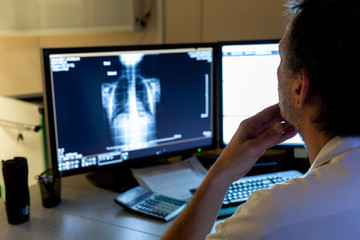 Interprétation radiographie pulmonaire coronavirus sur écran bureau par médecin radiologue