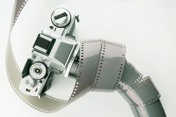 Film slr camera and a roll of 35mm negative film. Film camera and negative film. 