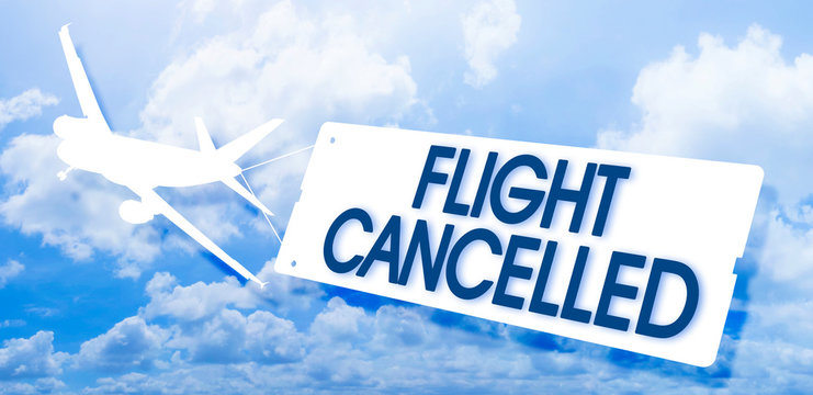 Flight cancelled concept image with airplane icon flying and towing a signboard against a cloudy sky