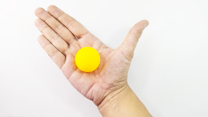Man hand in hand with orange ping pong ball.