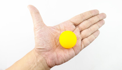 Man hand in hand with orange ping pong ball.