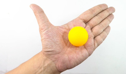 Man hand in hand with orange ping pong ball.