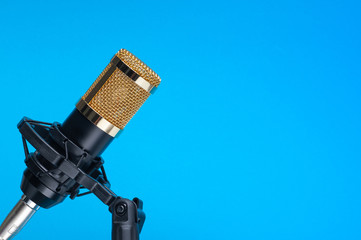 Studio microphone for recording podcasts, songs, and radio programs on a blue background with a...