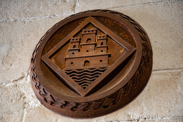 rusty shield with the symbol of the fortress of Santa Barbara
