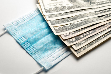 a medical bandage on his face lies next to a pack of dollars. Bribe to the doctor, purchase of a remedy against coronavirus. Horizontal frame