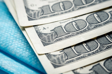 a medical bandage on his face lies next to a pack of dollars. Bribe to the doctor, purchase of a remedy against coronavirus. Horizontal frame