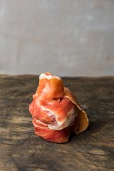 tasty canapes with meat on a small skewer on a gray background. Vertical frame