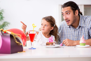 Father celebrating birthday with his daughter