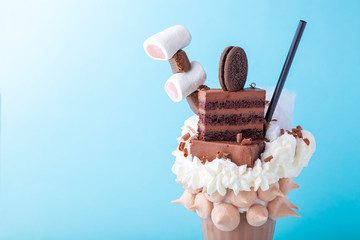 Chocolate milk freakshake with whipped cream, marshmallow, cake, cookie