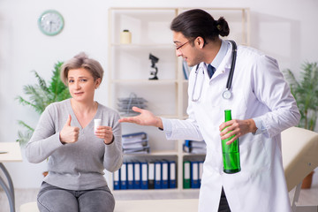 Female alcoholic visiting young male doctor