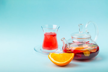Fruit tea with berries in kettle, turkish shape tea cup