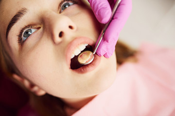 Little girl visiting dentist in clinic. Conception of stomatology