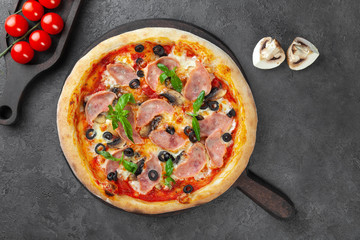 Meat pizza with carbonate, olives, mushrooms, tomatoes, basil, cheese