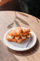 Banana croissant and coffee. Cafe.