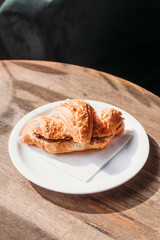 Fresh croissant with chocolate filling. Breakfast at the cafe.
