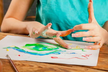 Obraz premium Art as psychological therapy for mental health. Young beautiful woman painting with fingers. Inspiration and creativity concept. Selective focus.