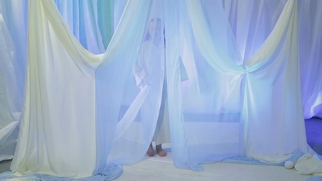 Young Jewish bride rehearsing an exit under the chuppah before the wedding