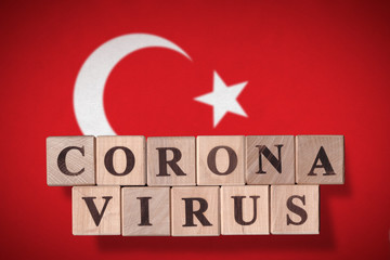 Flag of Turkey with wooden cubes spelling coronavirus on it. 2019 - 2020 Novel Coronavirus (2019-nCoV) concept, for an outbreak occurs in Turkey.