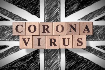 Black and white hand drawn flag of United Kingdom with wooden cubes spelling coronavirus on it. 2019 - 2020 Novel Coronavirus (2019-nCoV) concept, for an outbreak occurs in UK.