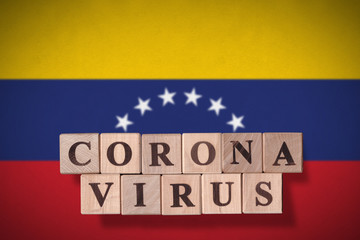 Flag of Venezuela with wooden cubes spelling coronavirus on it. 2019 - 2020 Novel Coronavirus (2019-nCoV) concept, for an outbreak occurs in Venezuela.