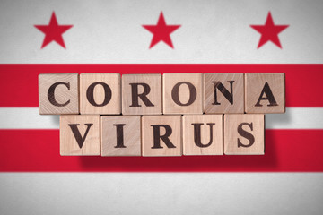 Flag of the city of Washington DC with wooden cubes spelling coronavirus on it. 2019 - 2020 Novel Coronavirus (2019-nCoV) concept, for an outbreak occurs in Washington DC, US.