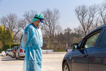 Doctor talking with a patient on a Driv-In Coronavrius Test station