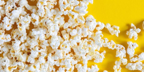 Popcorn on yellow background. Popcorn pattern. Flat lay, top view, copy space