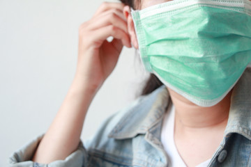 Woman wearing medical face mask for protection.