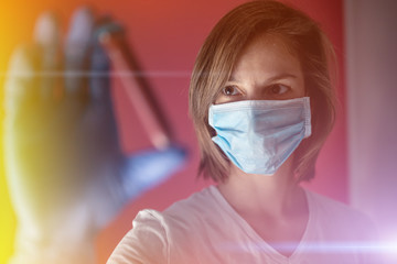 nurse wearing a mask, analyzes test tube of blood infected by coronavirus, generated in china, widespread in Italy and also arrived in the us with the risk of a 2019-ncov flu pandemic and deaths 