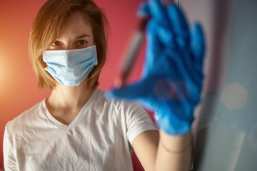nurse wearing a mask, analyzes test tube of blood infected by coronavirus, generated in china, widespread in Italy and also arrived in the us with the risk of a 2019-ncov flu pandemic and deaths 