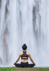 Young woman do yoga relax at the waterfall outdoors nature background. .