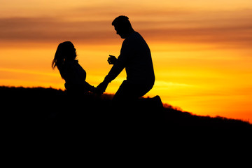 Fototapeta na wymiar Lovers couple in sunset time in nature ( shilouette )