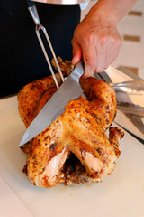 spice marinated and oven roasted turkey on a white board, ready to carve for festive season