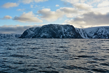 Nordkapp with snowy cliffs and blue water of Barents Sea