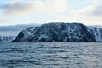 Nordkapp with snowy cliffs and blue water of Barents Sea