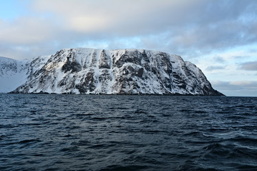 Nordkapp  -View from a sailing boat on snowy hills.