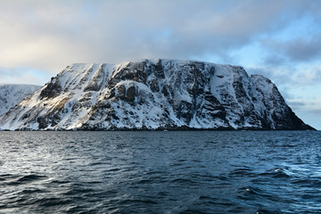 Nordkapp with snowy cliffs and blue water of Barents Sea