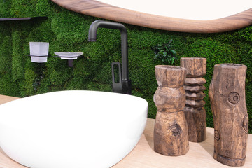 Luxury mixer on a white sink in a beautiful green  bathroom
