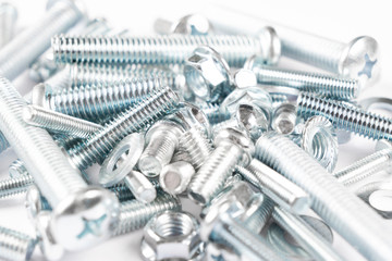 Metal bolts and nuts  in a row background. Chromed screw bolts and nuts isolated. Steel bolts and nuts pattern. Set of Nuts and bolts. Tools for work.