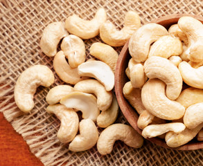 Cashews in a wooden plate. The view from top.