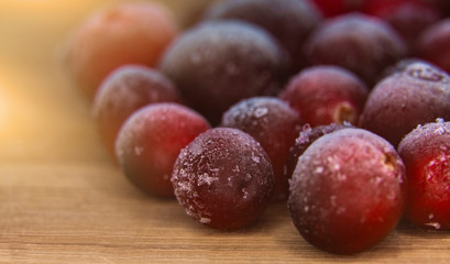 Many frozen cranberries. Closeup of red berries in hoarfrost.