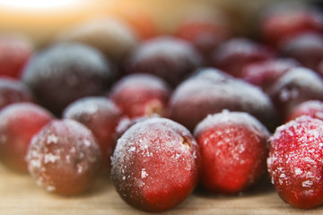 Many frozen cranberries. Closeup of red berries in hoarfrost.