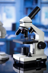 Modern scientific laboratory interior. Reaserch station with microscopes on the glass table.