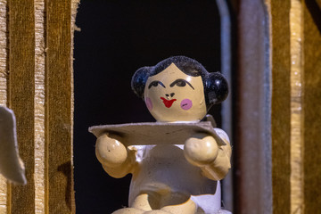 wooden doll on a black background