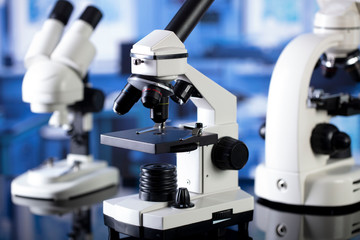 Modern scientific laboratory interior. Reaserch station with microscopes on the glass table.