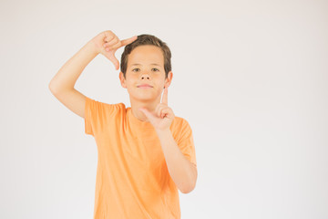 Boy making gesture and looking into camera